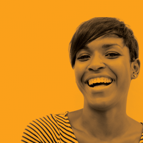 woman laughing on a orange background