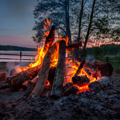 bonfire at dusk on a lake